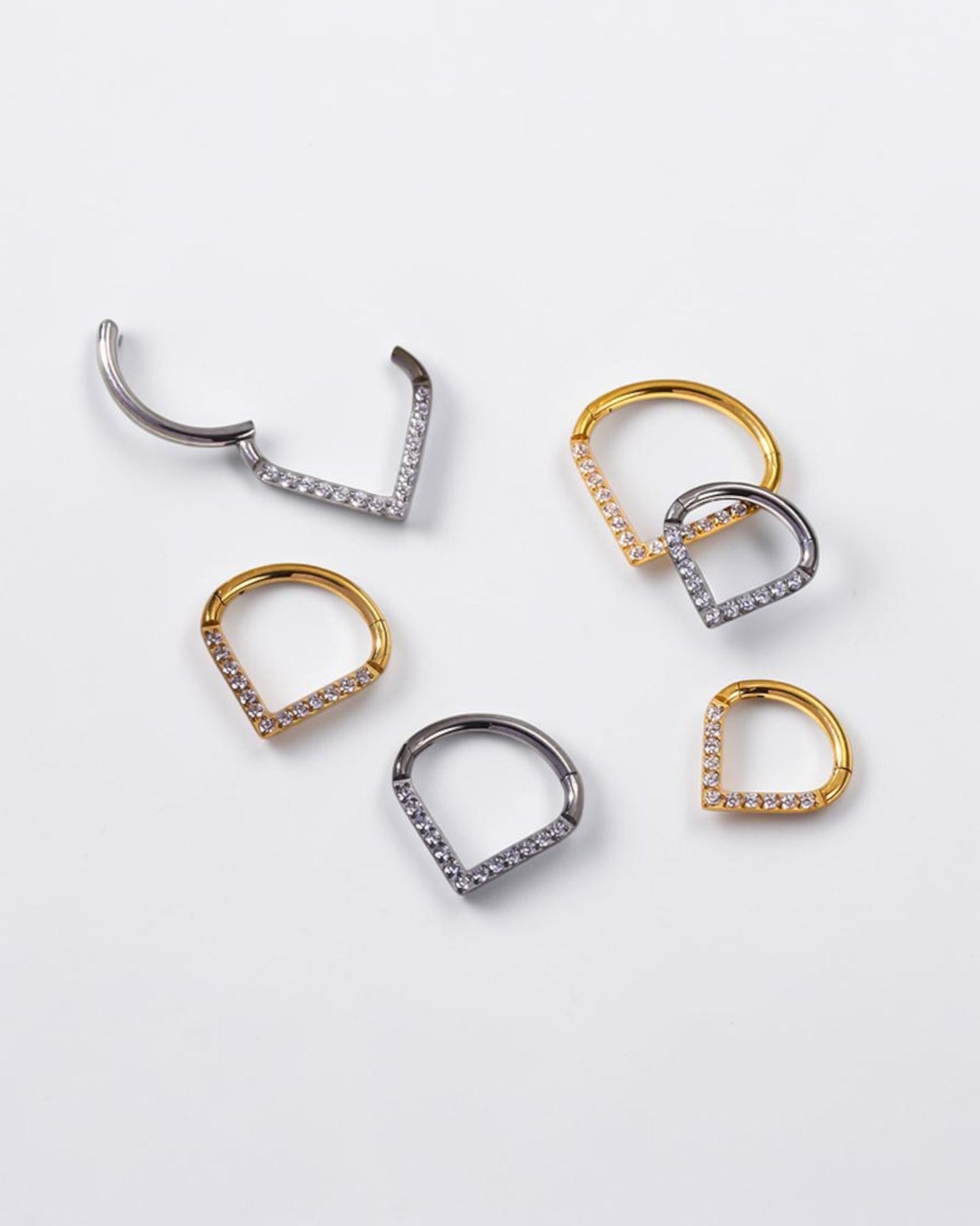 Odonata gold and silver clicker earrings with V-shaped design and white cubic zirconia, 10mm diameter.