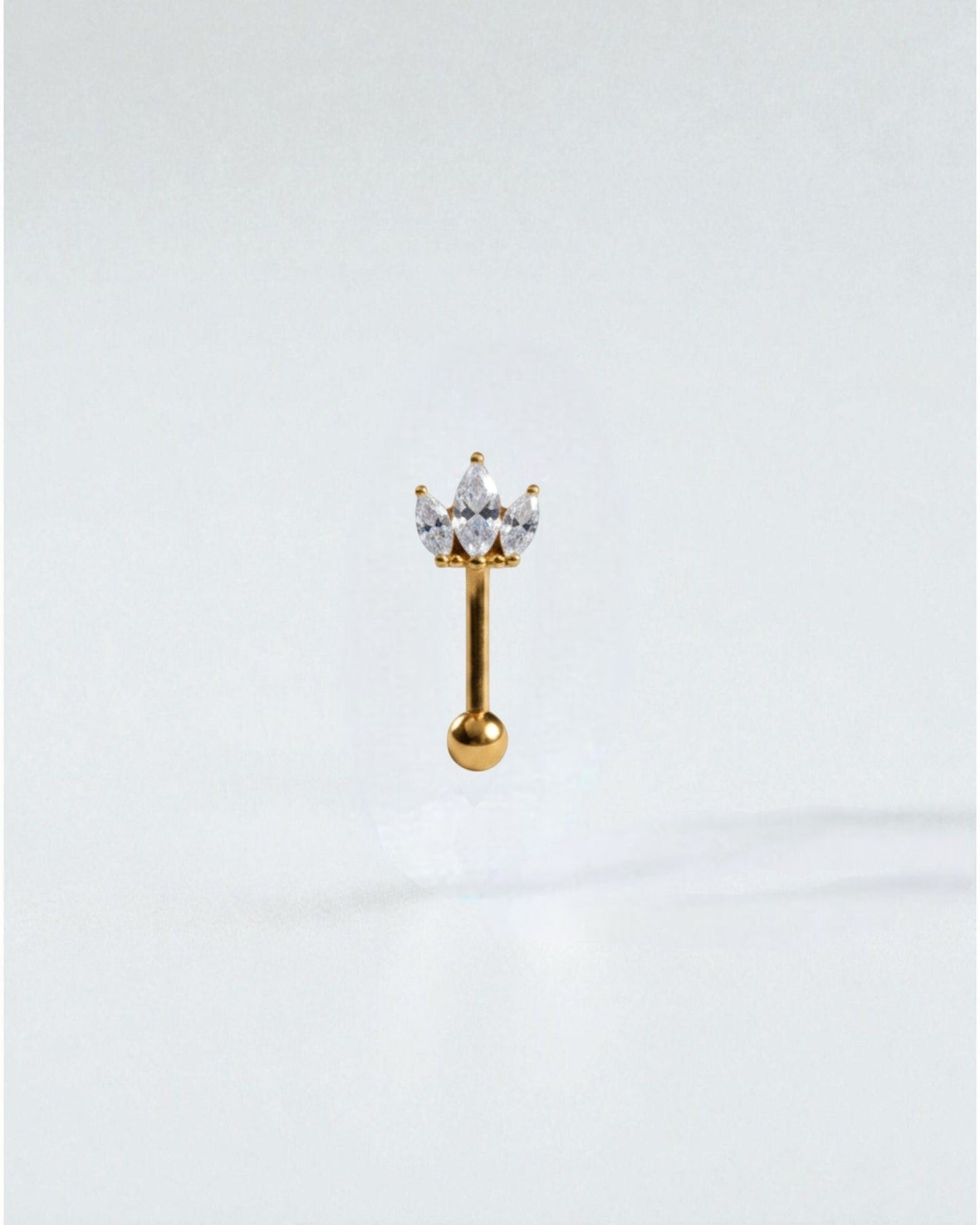 Odonata banana barbell eyebrow ring with a crown design of marquise-cut white cubic zirconia. Made of titanium.