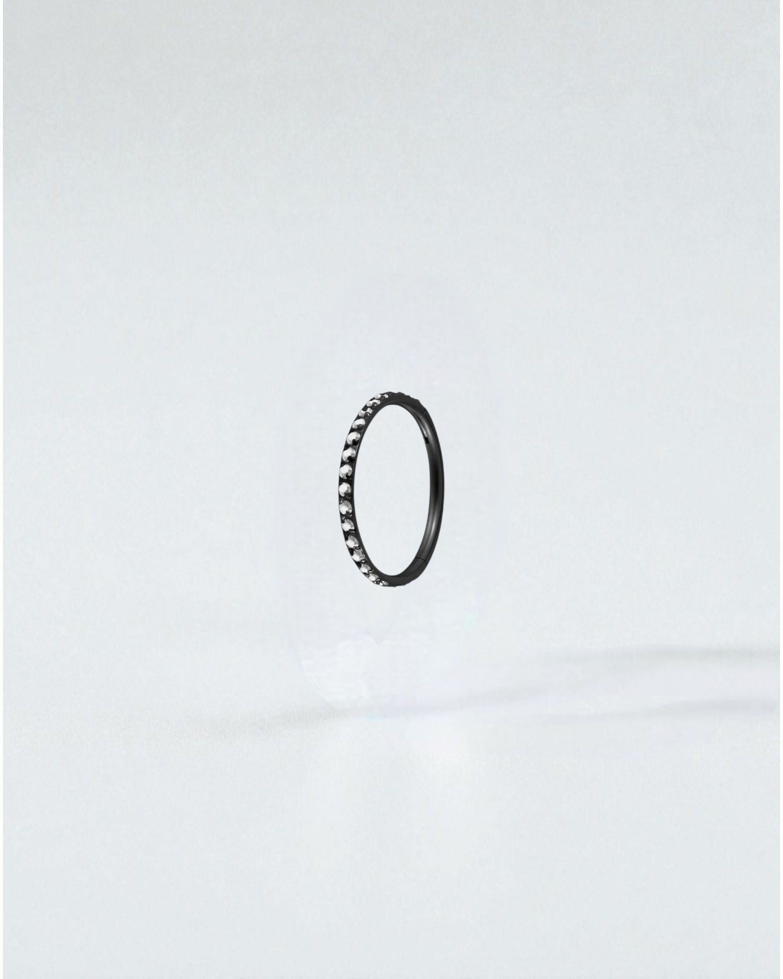 Odonata black titanium clicker hoop earring with clear crystals, 6mm diameter, 18g.