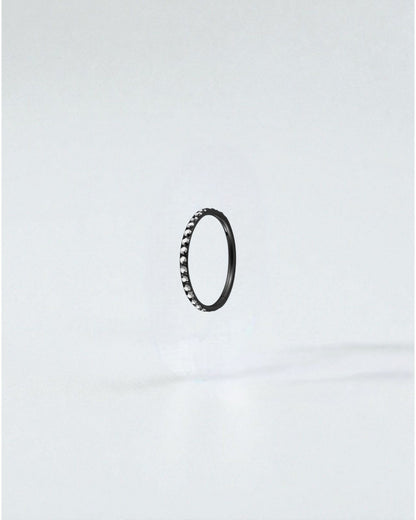 Odonata black titanium clicker hoop earring with clear crystals, 6mm diameter, 18g.