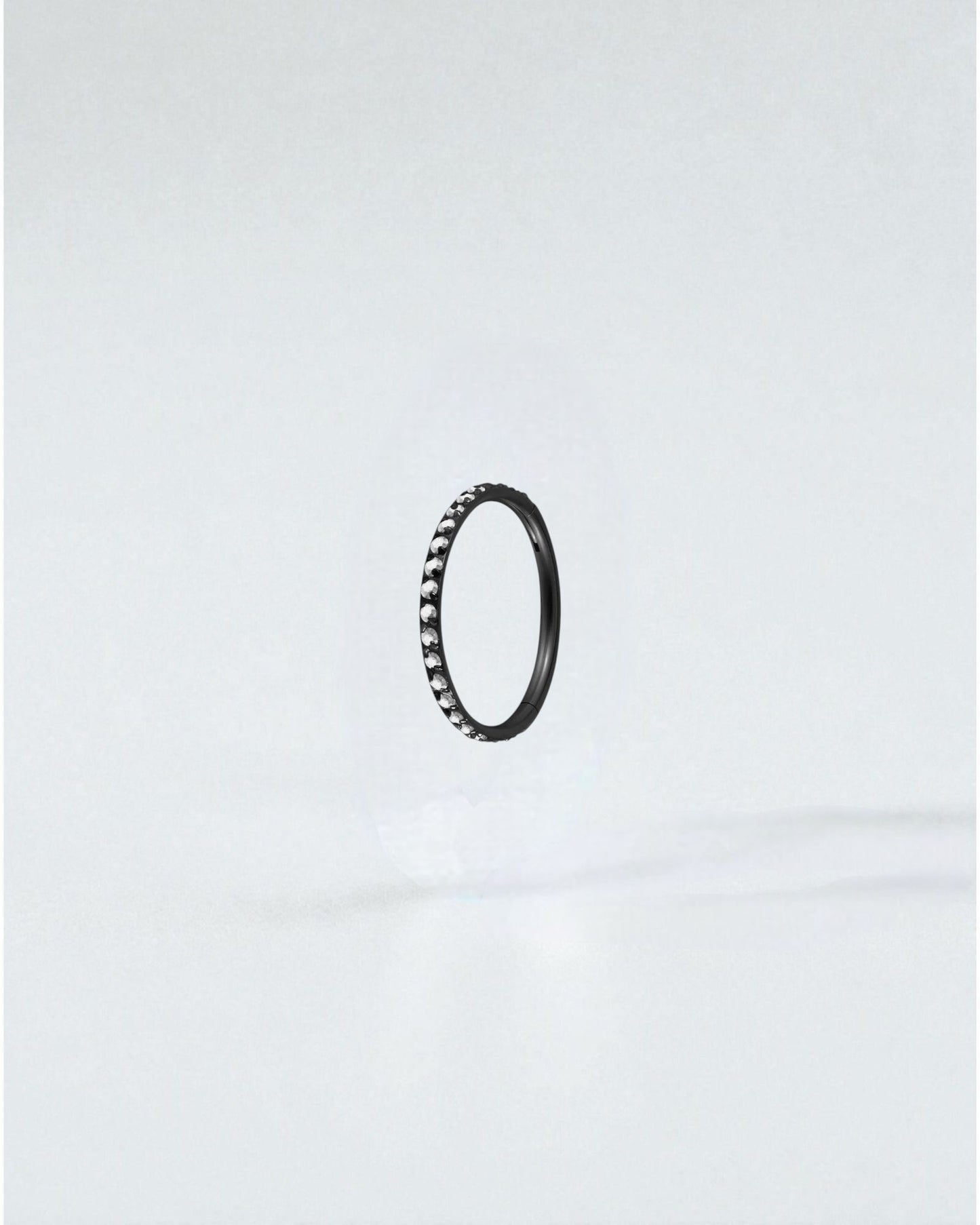 Odonata black titanium clicker hoop earring with clear crystals, 8mm diameter, 18g gauge.