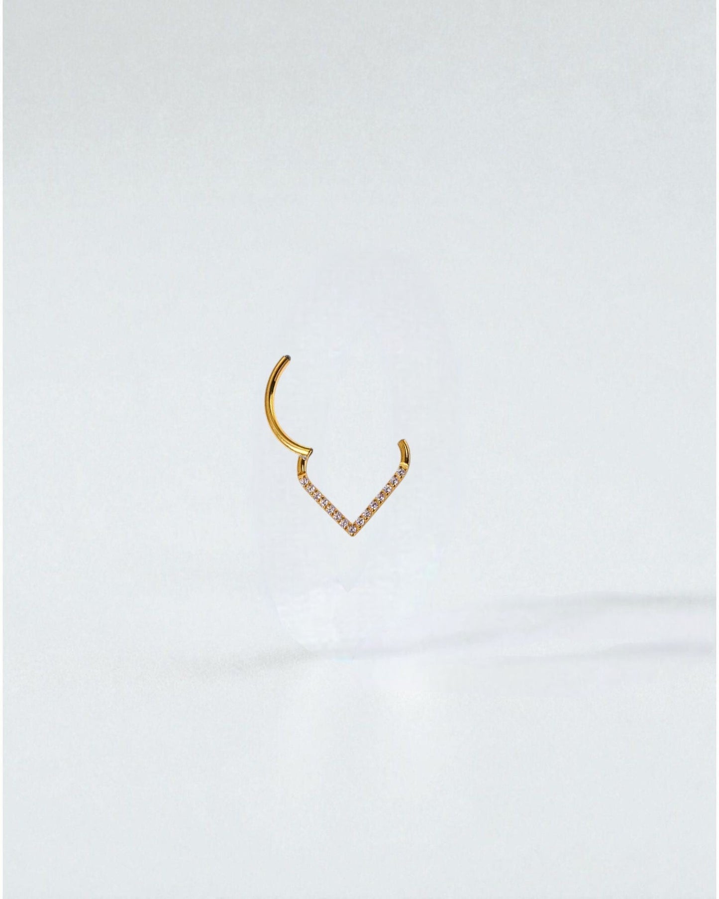 Odonata gold and silver clicker earrings with V-shaped design and white cubic zirconia stones, 8mm diameter.