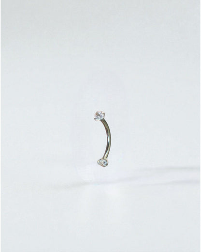Odonata curved barbell 10mm titanium with two clear cubic zirconia ends, ideal for eyebrow piercings.