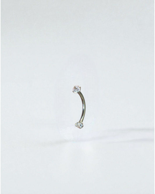 Odonata curved barbell 10mm titanium with two clear cubic zirconia ends, ideal for eyebrow piercings.