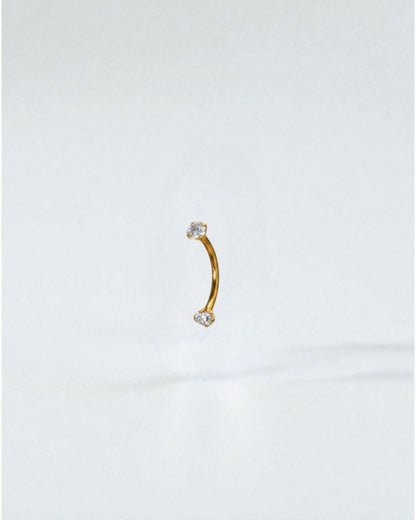 Odonata curved titanium barbell with clear cubic zirconia ends, 10mm length, 16G thickness. Ideal for eyebrow piercings.