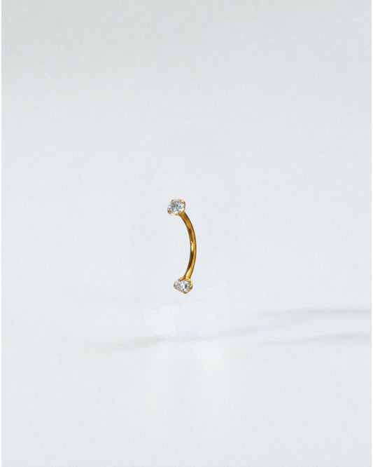 Odonata curved titanium barbell with clear cubic zirconia ends, 10mm length, 16G thickness. Ideal for eyebrow piercings.