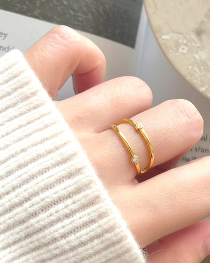 Odonata minimalist double band ring in polished sterling silver with 18k gold plating and cubic zirconia accents.