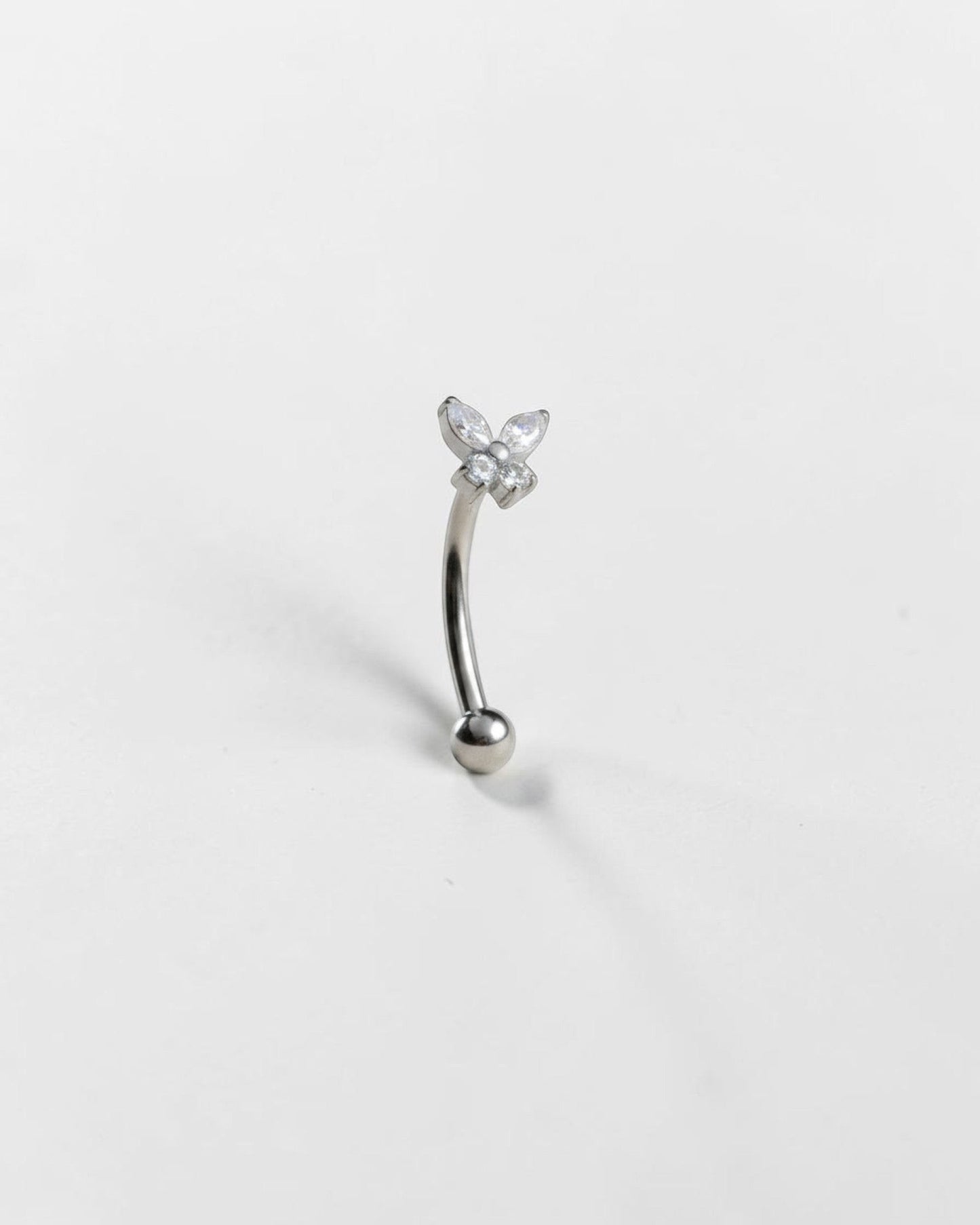 Odonata gold banana barbell with butterfly design featuring white cubic zirconia. Titanium grade implant.