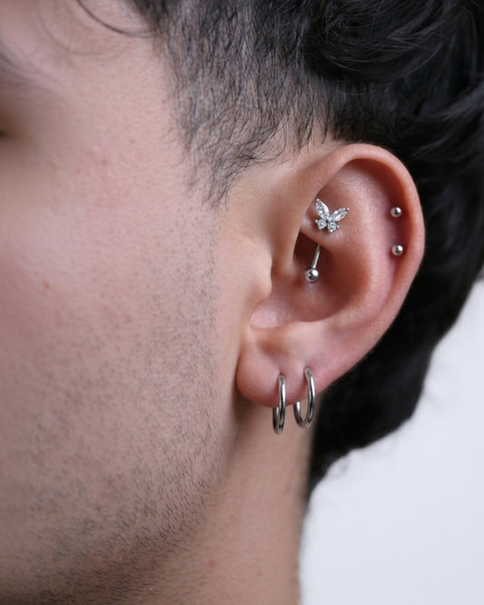 Odonata gold banana earring with white cubic zirconia butterfly design, suitable for sensitive ears.