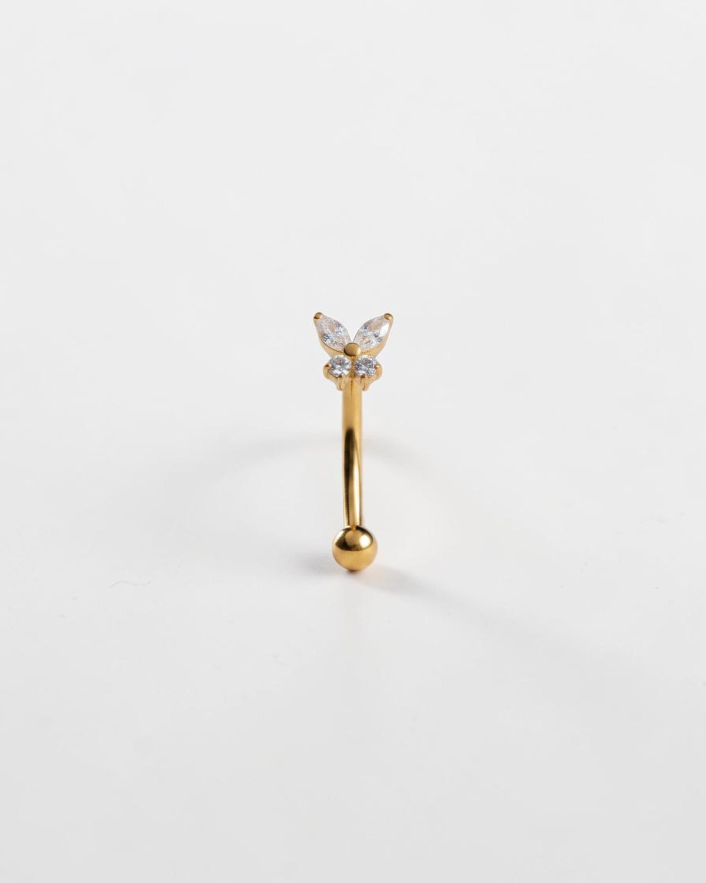 Odonata gold titanium eyebrow ring with butterfly design featuring clear cubic zirconia. Internal thread closure.