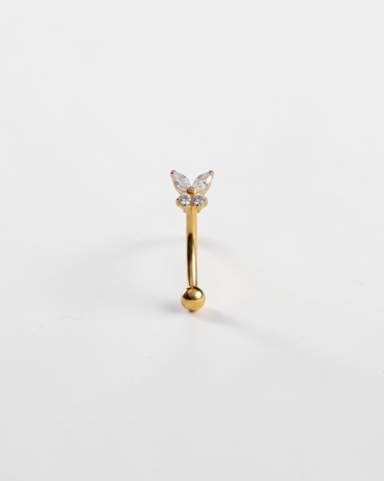 Odonata gold titanium eyebrow ring with butterfly design featuring clear cubic zirconia. Internal thread closure.