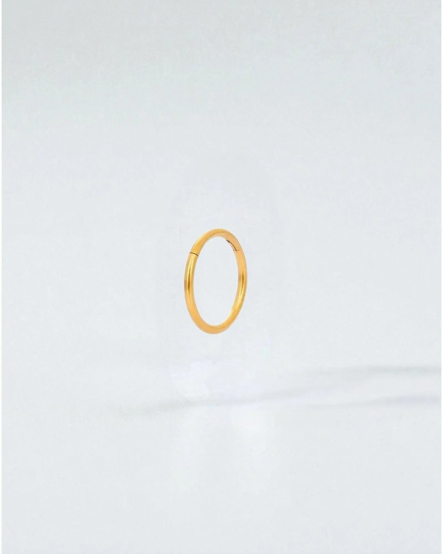 Odonata gold-plated stainless steel clicker hoop earring, 8mm inner diameter, for a minimalist look.