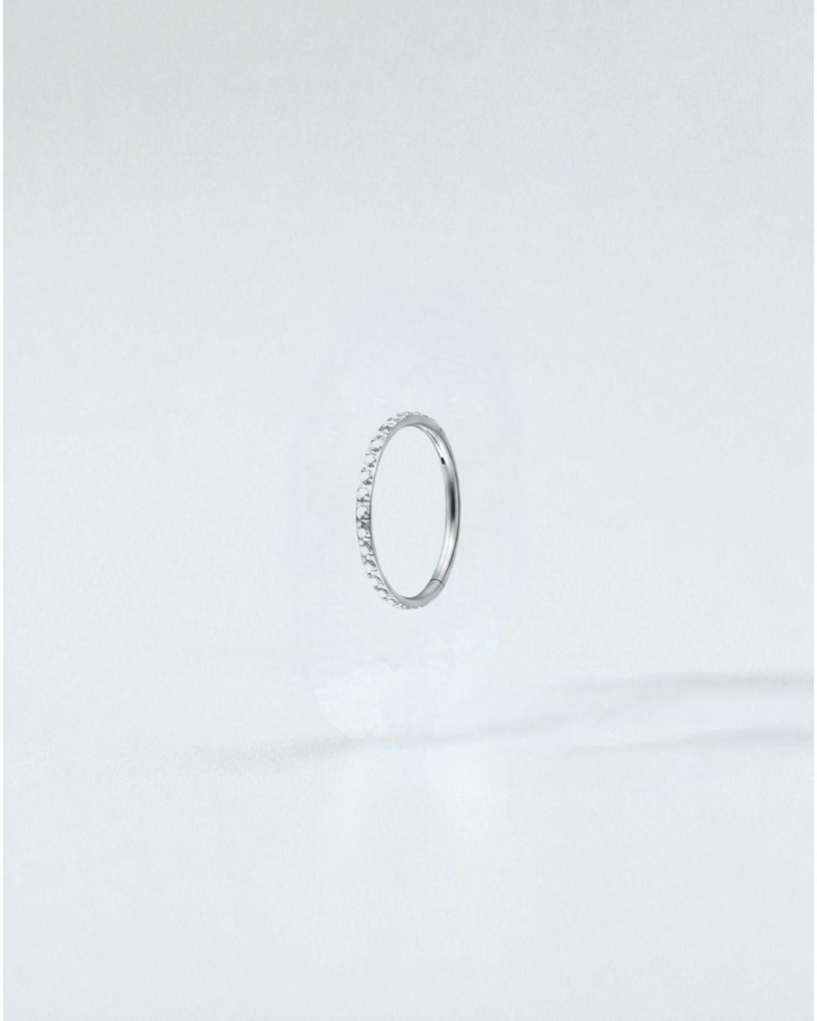 Odonata gold titanium clicker hoop earring with clear cubic zirconia stones, 8mm diameter.