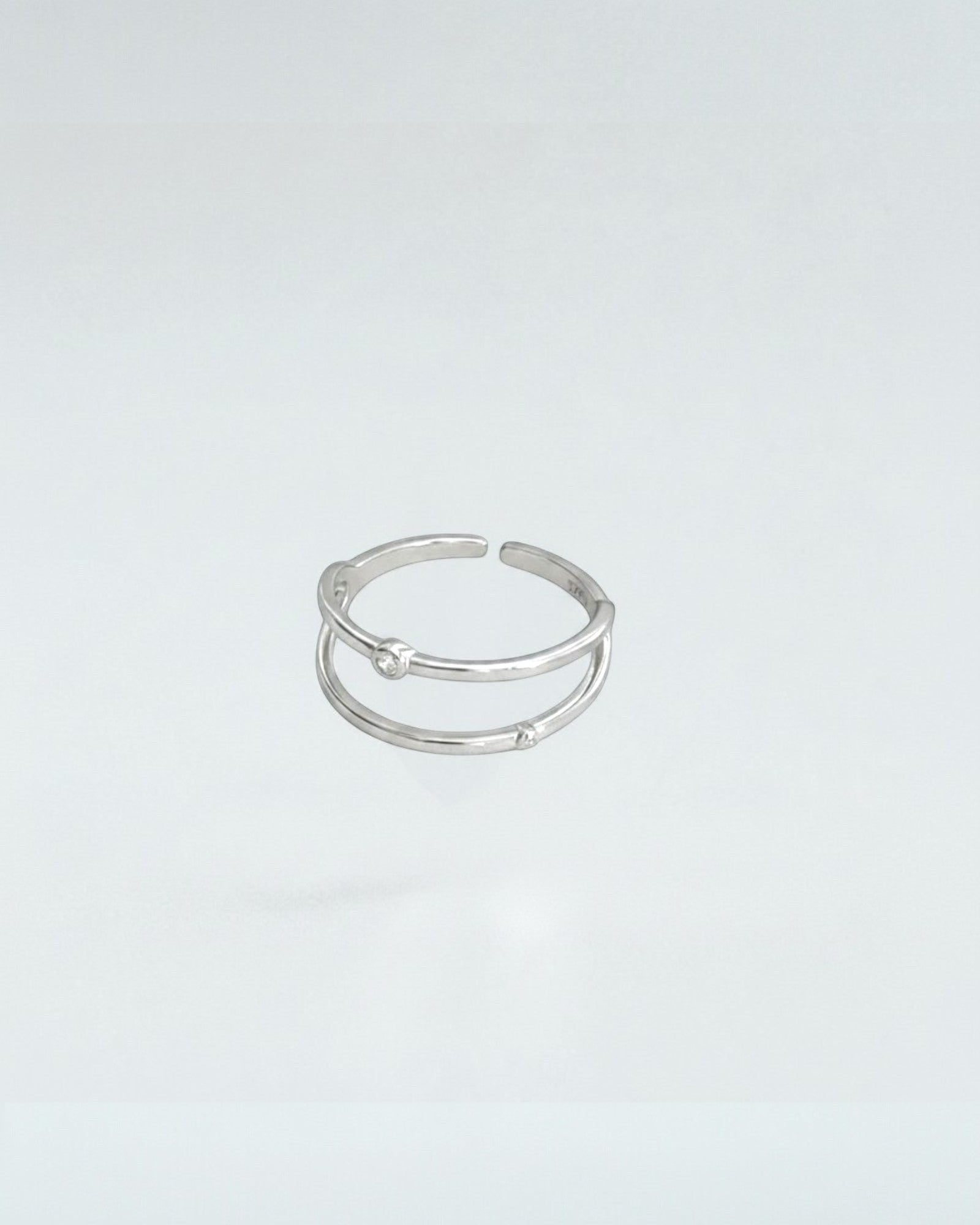 Odonata gold-plated sterling silver open ring with double geometric lines and cubic zirconia accents. Adjustable.