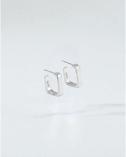 Odonata gold-plated sterling silver geometric semi-square huggie earrings, minimalist and elegant for daily wear.