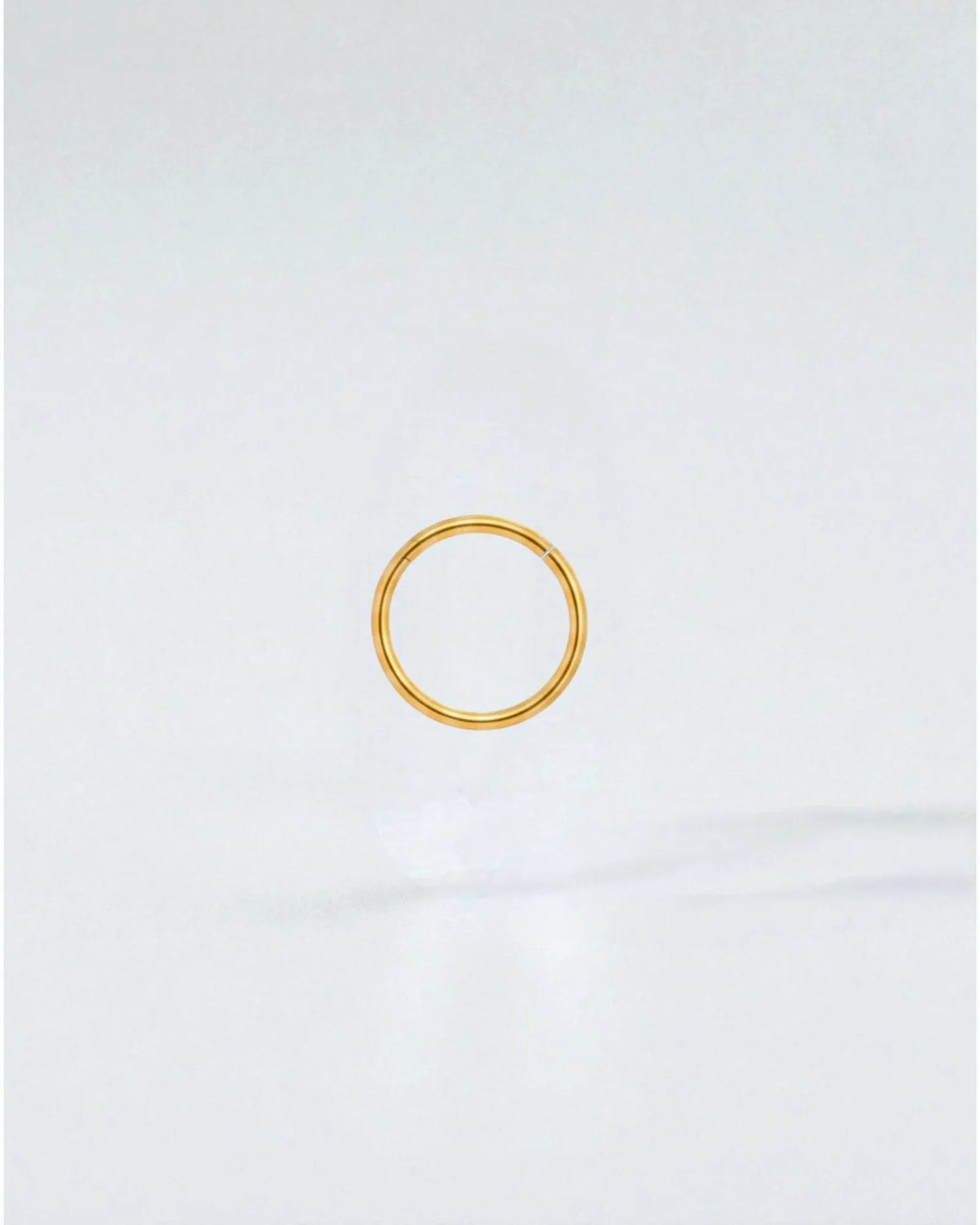 Odonata gold-plated stainless steel 8mm clicker hoop earring with a clean, minimalist design for everyday wear.