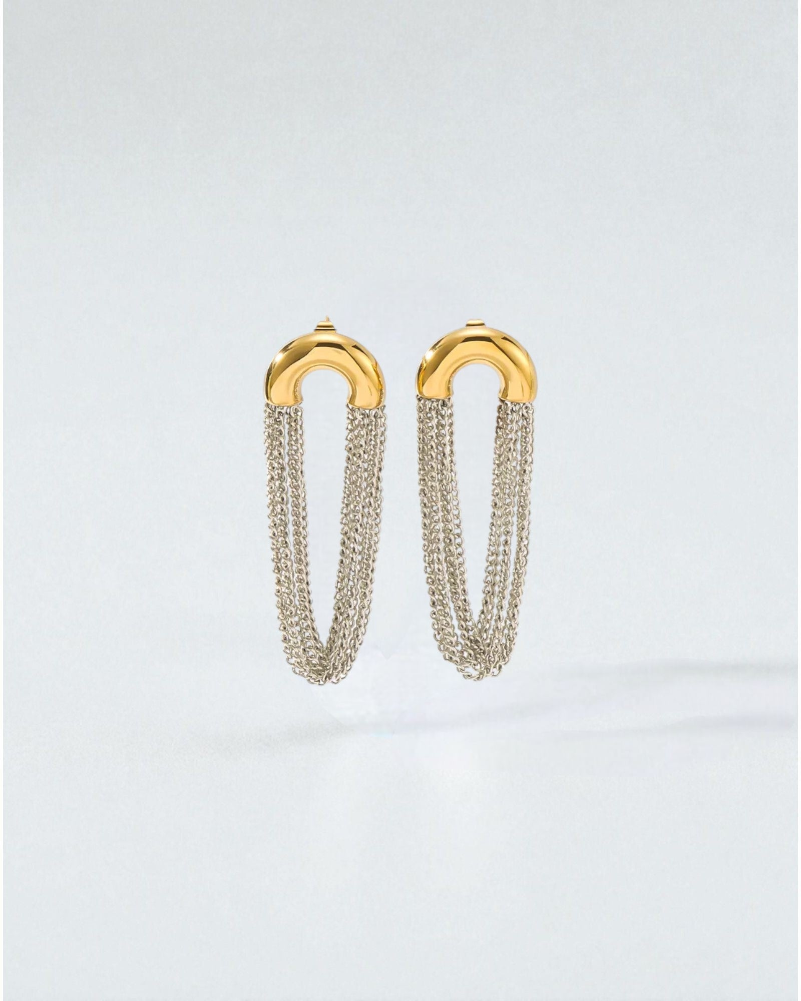 Odonata gold-plated stainless steel earrings with cascading silver chains. Elegant drop design.