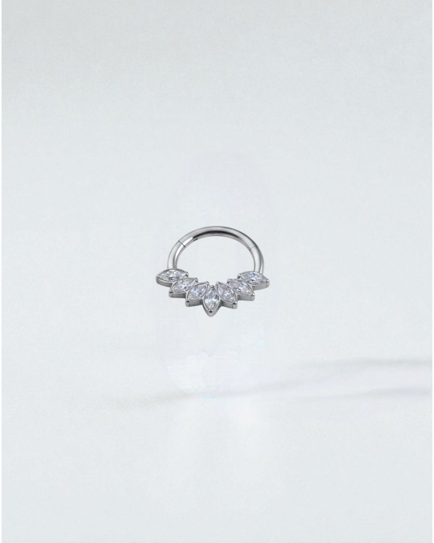 Odonata gold titanium clicker septum or daith piercing with marquise-cut clear cubic zirconia stones arranged in a fan shape.
