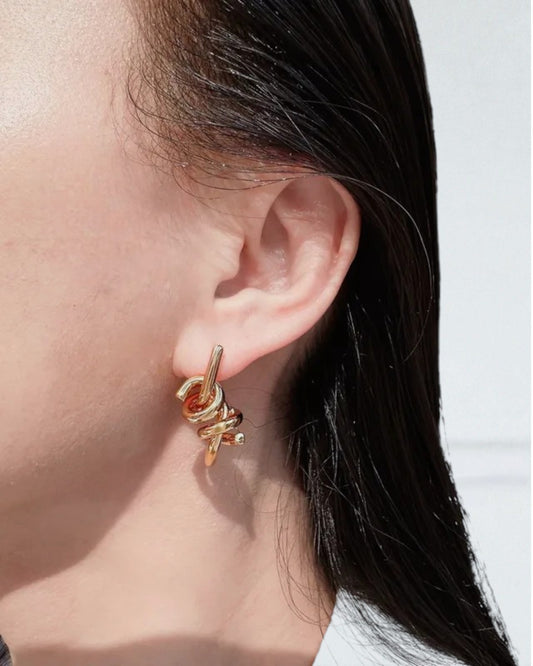 Odonata gold plated brass twist earrings with a knot design.
