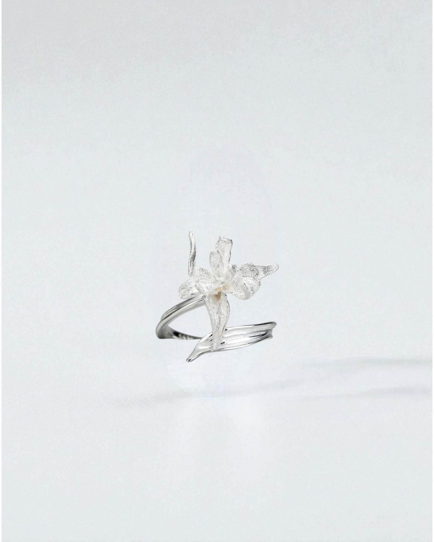 Odonata sculpted silver flower ring with double open band, matte finish, and detailed petals.