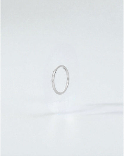 Odonata silver stainless steel clicker hoop earring with 10mm diameter, ideal for a minimalist look.