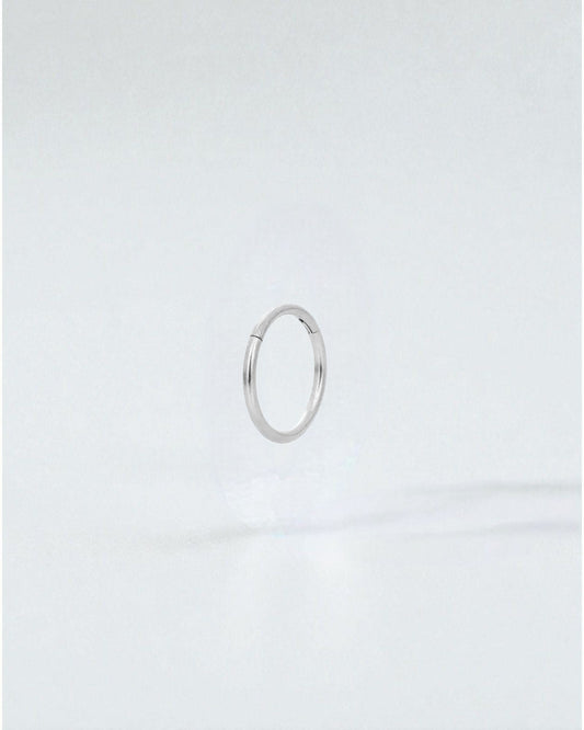 Odonata silver stainless steel clicker hoop earring with 10mm diameter, ideal for a minimalist look.