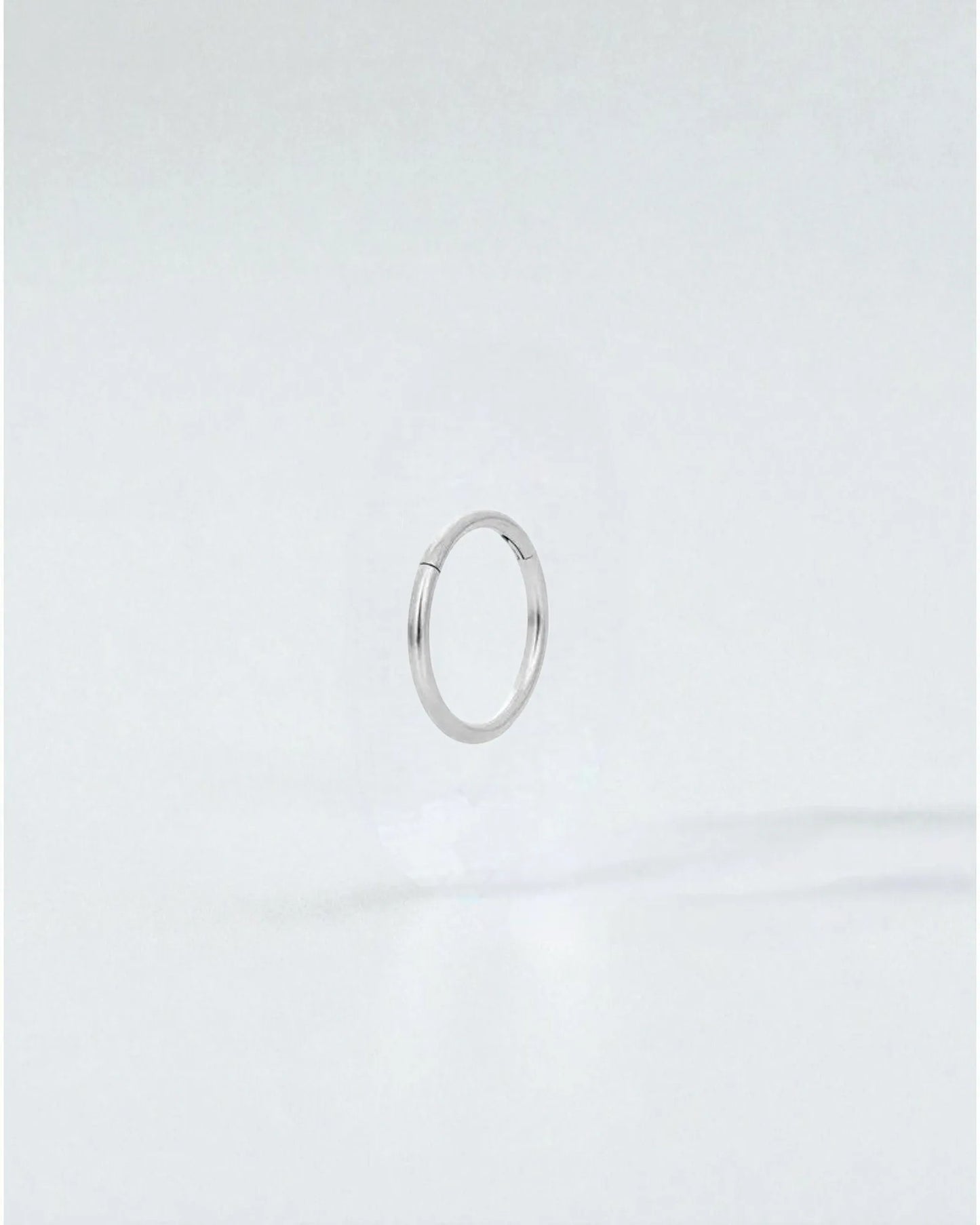 Odonata silver-tone stainless steel 8mm clicker hoop earring with a clean, minimalist design.