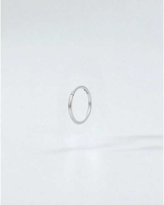 Odonata silver-tone stainless steel 8mm clicker hoop earring with a clean, minimalist design.