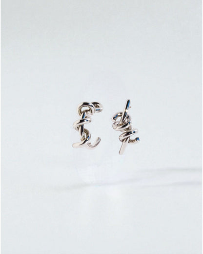 Odonata silver-tone brass twist hoop earrings with 24k gold plating. Modern sculptural design.