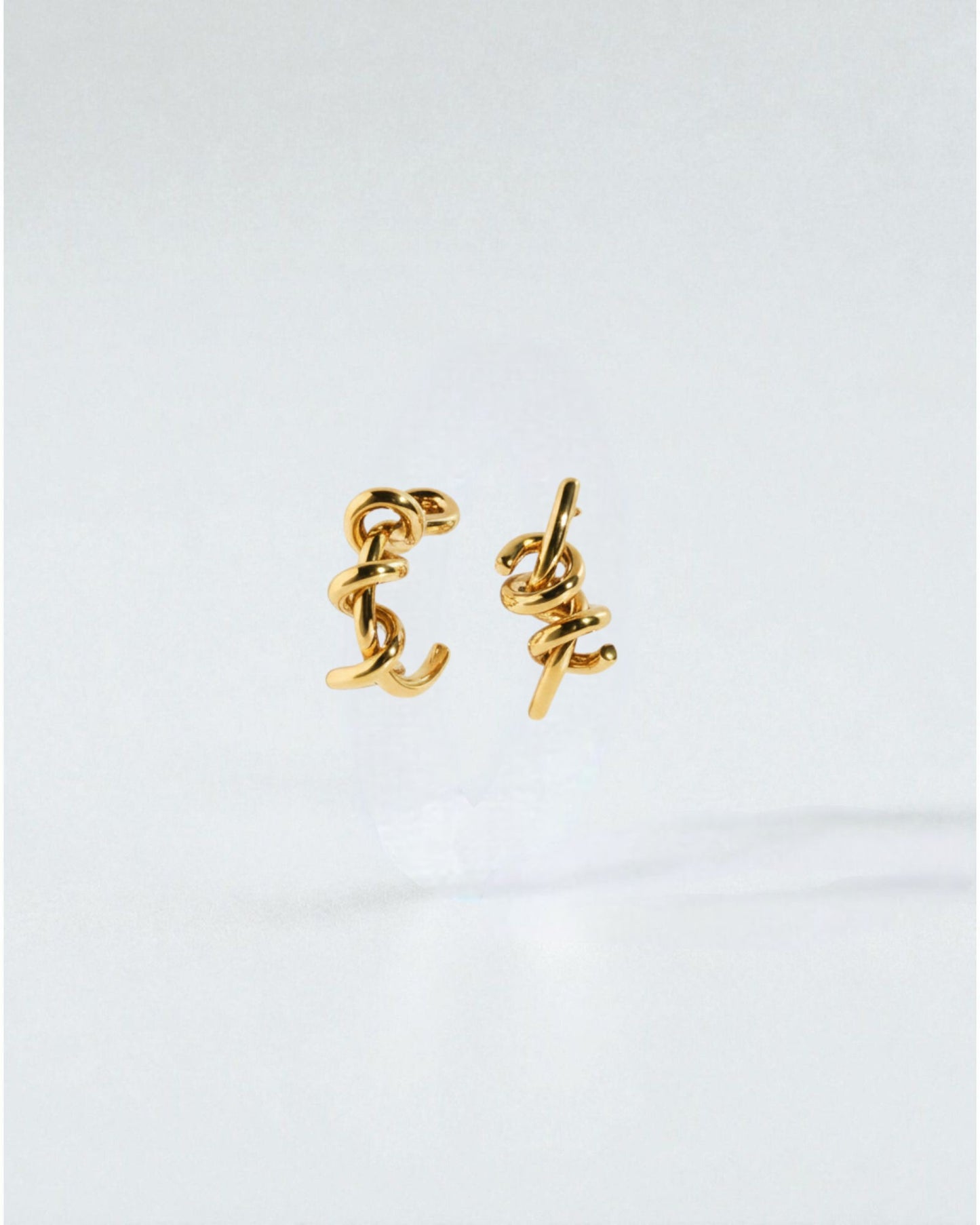 Odonata silver-tone brass twist earrings with 24k gold plating. Modern, sculptural design.