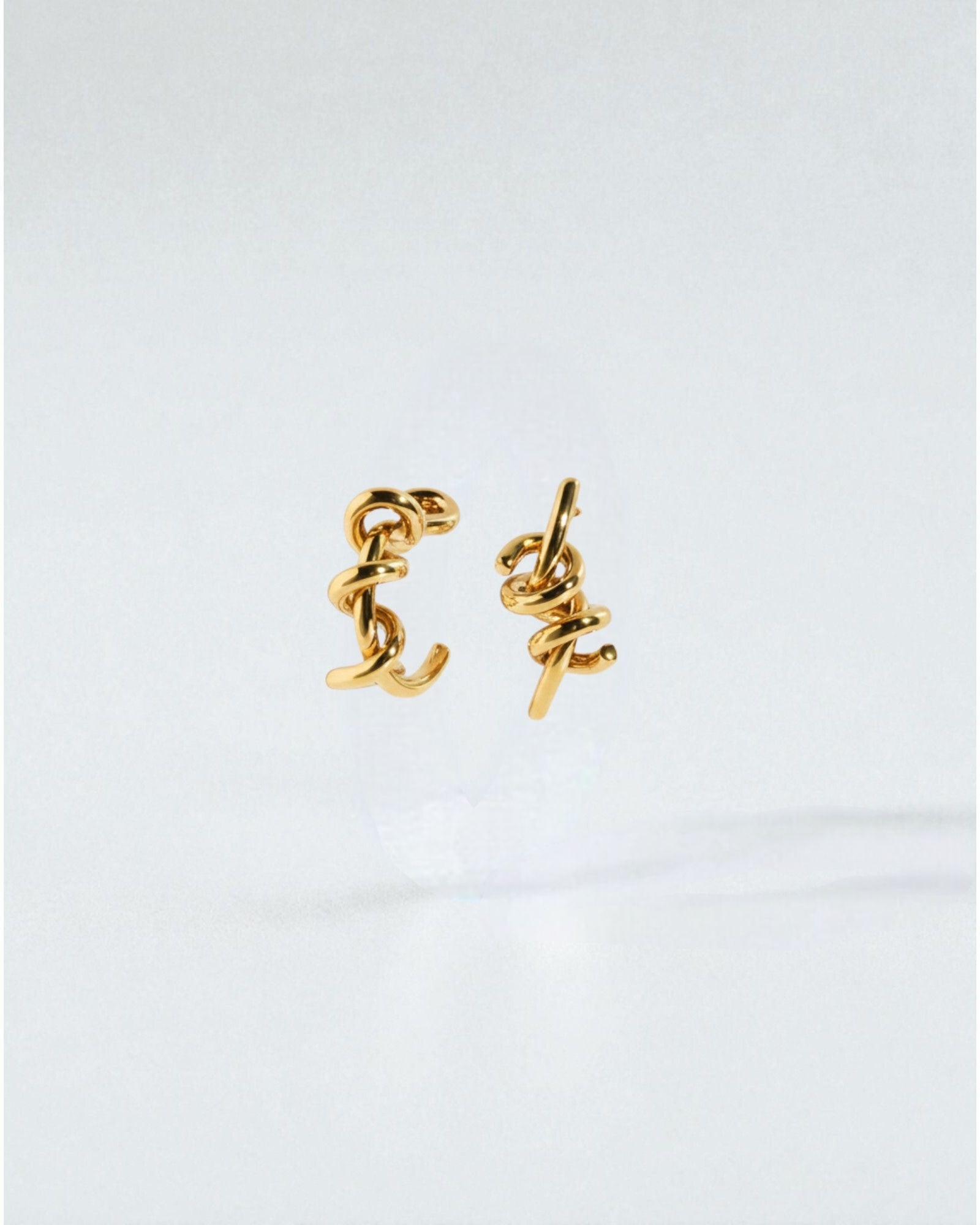 Odonata silver-tone brass twist earrings with 24k gold plating. Modern, sculptural design.