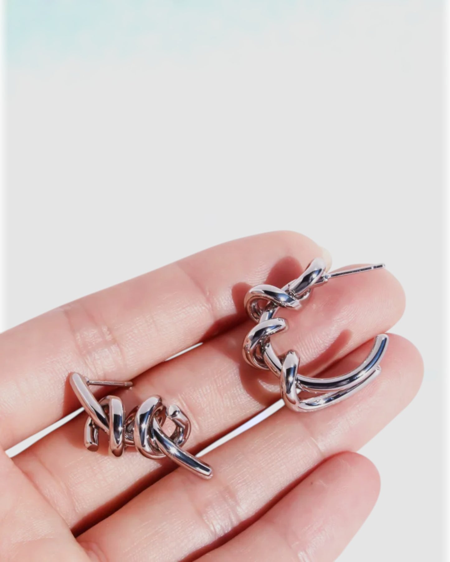 Odonata silver-tone brass twist hoop earrings with 24k gold plating.