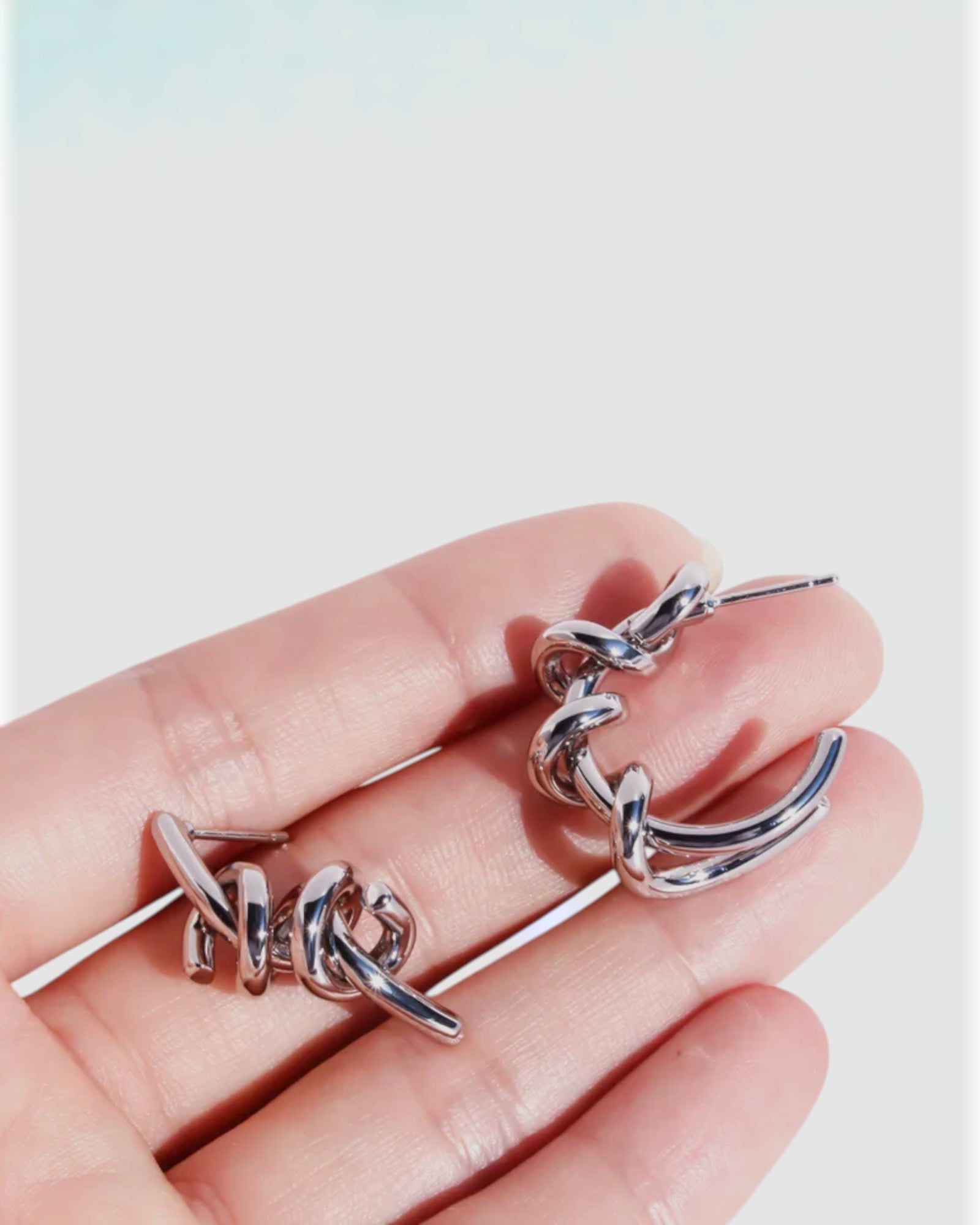 Odonata silver-tone brass twist hoop earrings with 24k gold plating.