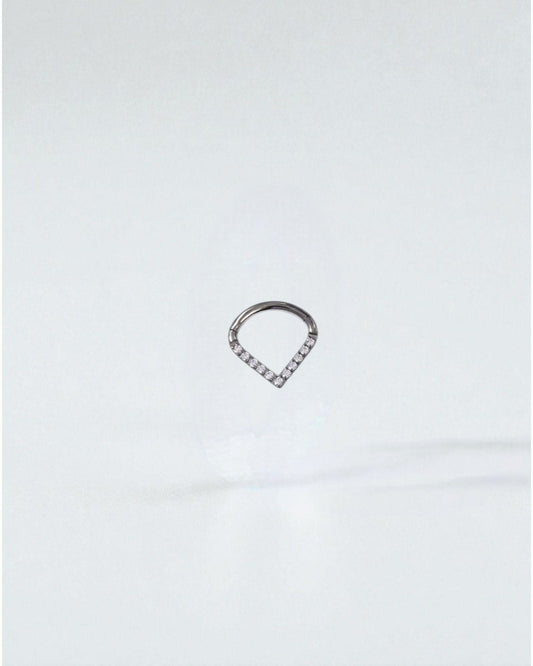 Odonata titanium clicker earring with white cubic zirconia in a V-shape, 8mm diameter, ideal for septum or daith piercings.