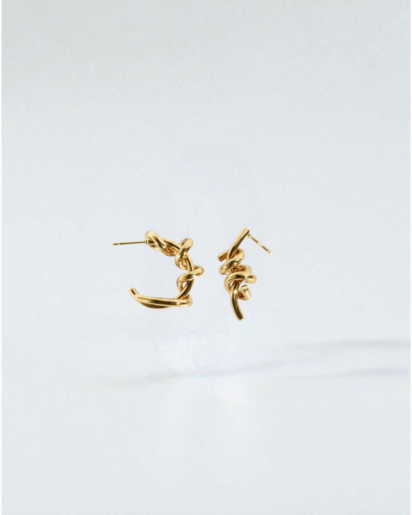 Odonata silver-tone brass twisted hoop earrings with 24k gold plating.
