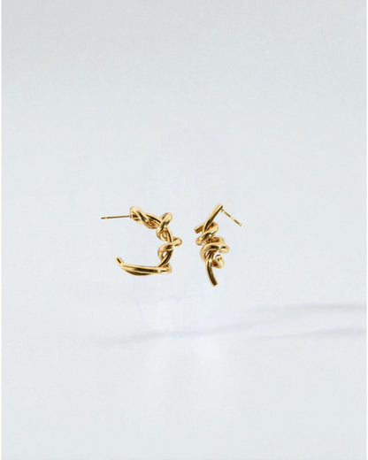 Odonata silver-tone brass twisted hoop earrings with 24k gold plating.