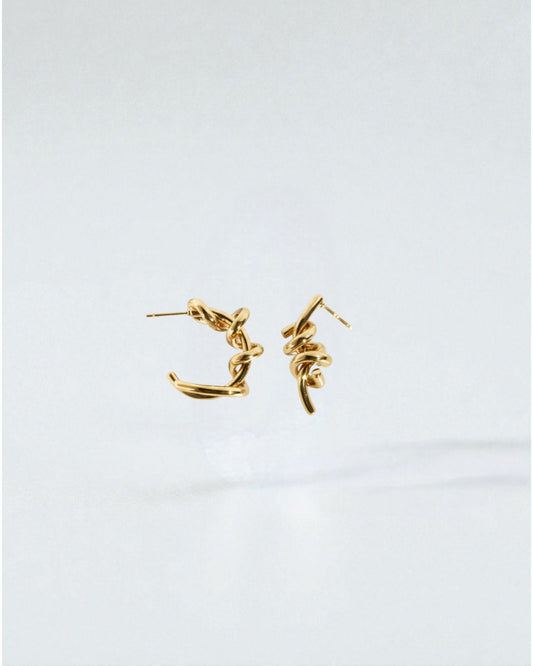Odonata silver-tone brass twisted hoop earrings with 24k gold plating.