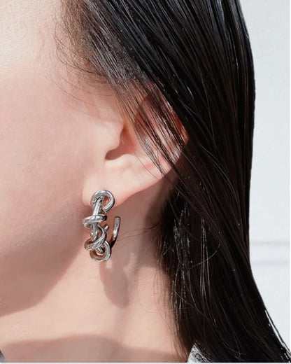 Odonata silver-tone brass hoop earrings with a twisted knot design, 24k gold plated.