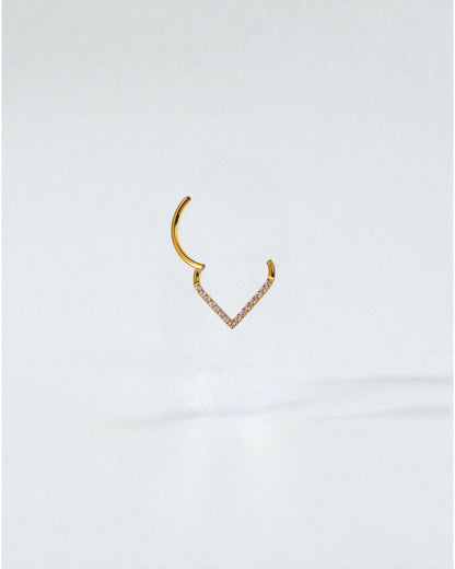 Odonata gold and silver clicker piercing with V-shaped design and white cubic zirconia stones.