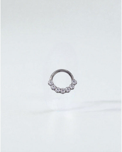 Odonata gold and silver clicker hoop earrings with 7 clear zirconias, 8mm size, 16G thickness, made of implant-grade titanium.
