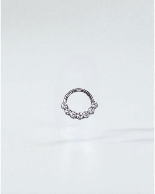 Odonata gold and silver clicker hoop earrings with 7 clear zirconias, 8mm size, 16G thickness, made of implant-grade titanium.