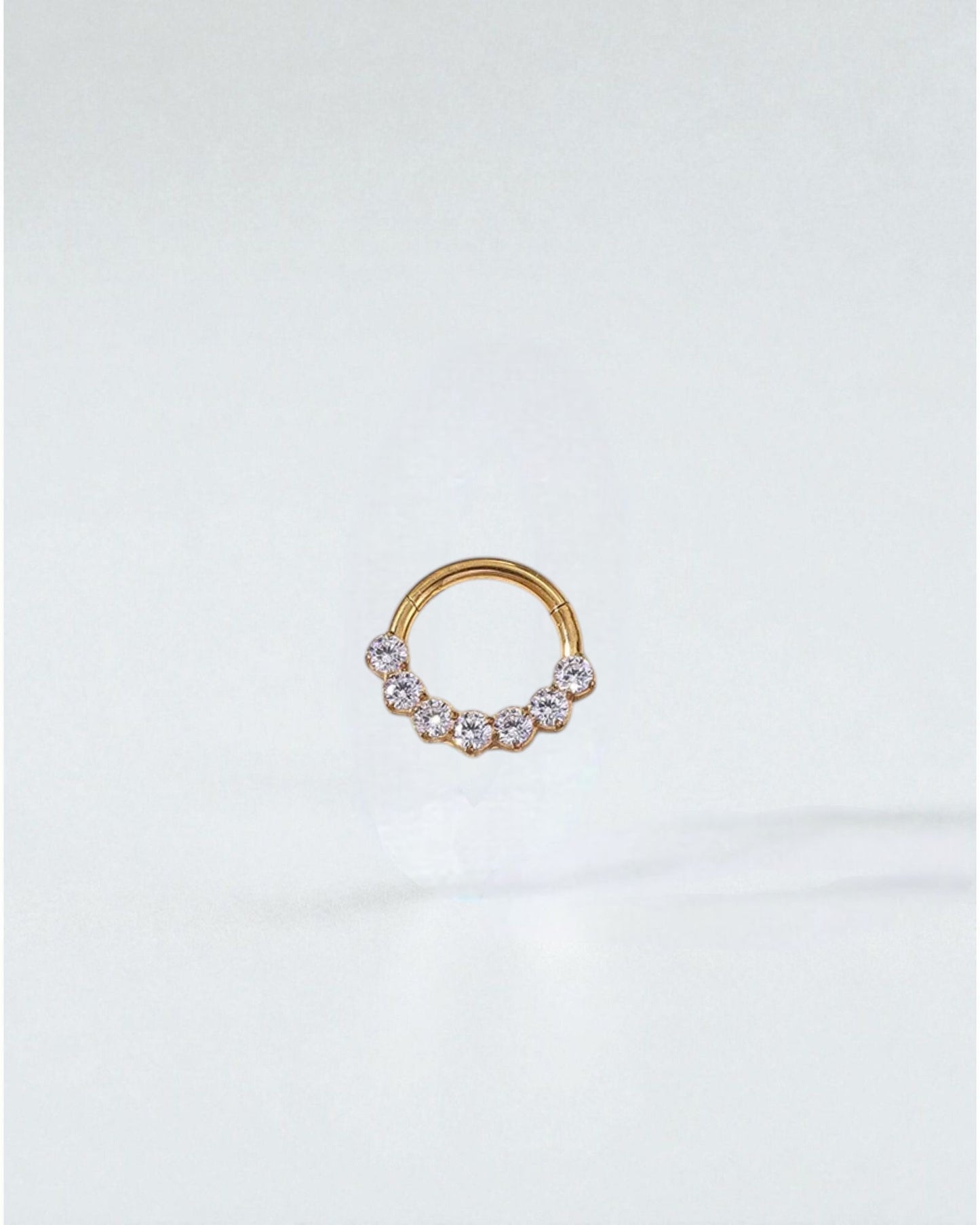 Odonata gold and silver clicker hoop earrings with 7 zirconias, 8mm, 16G, made of implant-grade titanium.
