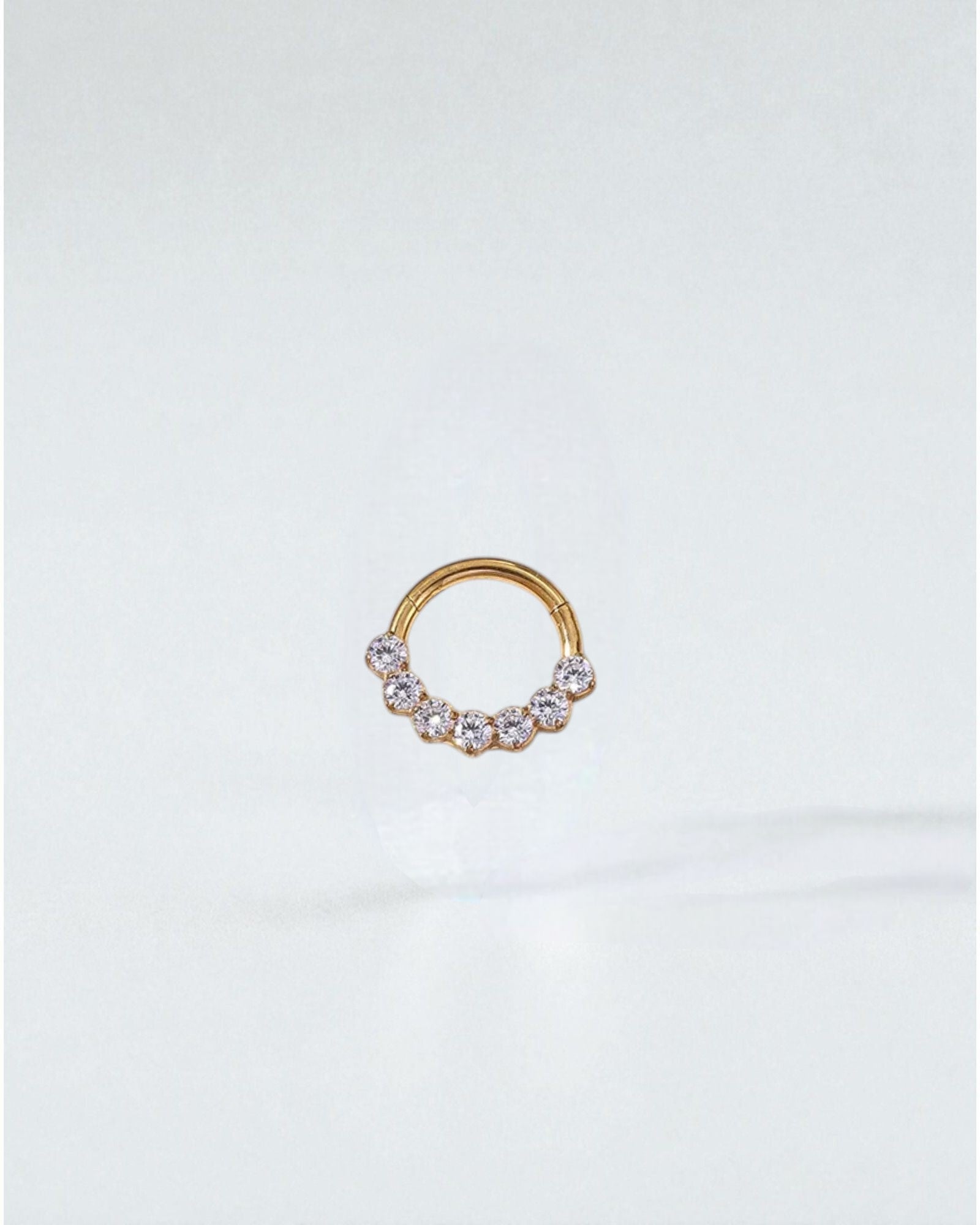 Odonata gold and silver clicker hoop earrings with 7 zirconias, 8mm, 16G, made of implant-grade titanium.